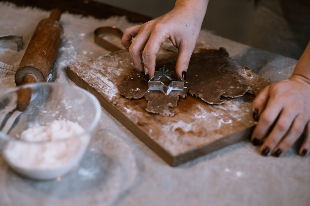 Cutting out gingerbread Christmas biscuits 3 - free stock photo