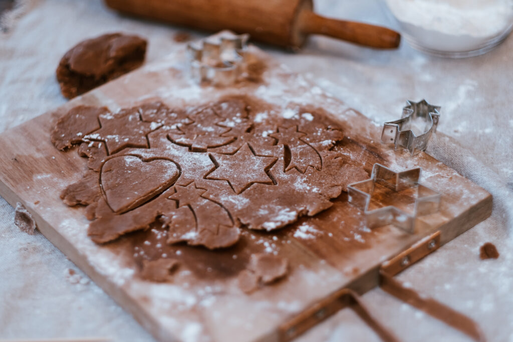Cutting out gingerbread Christmas biscuits 5 - free stock photo