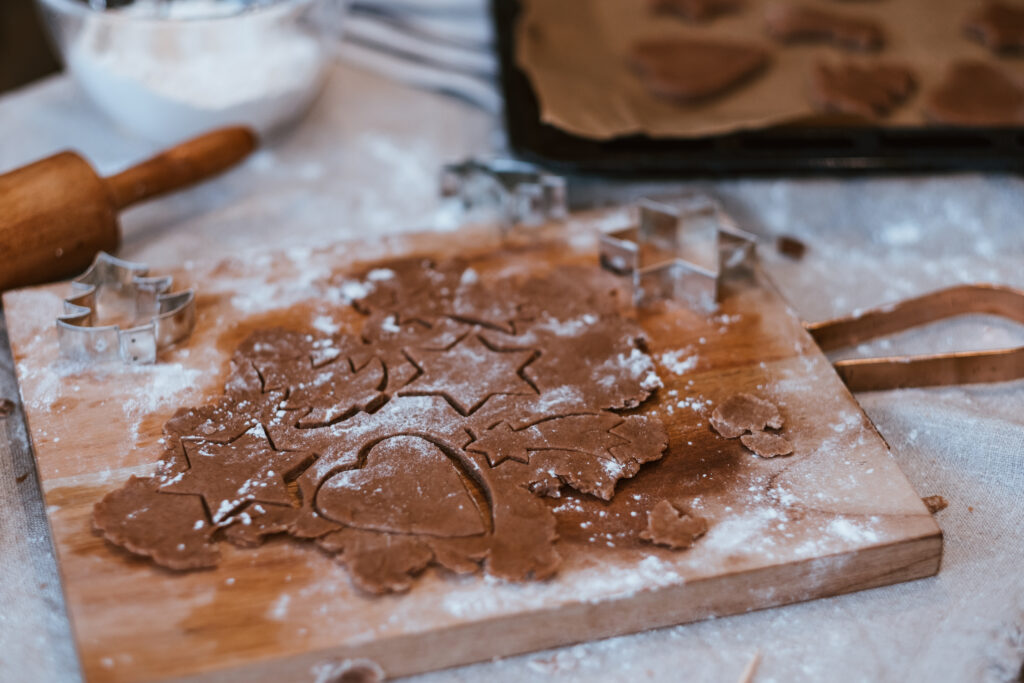 Cutting out gingerbread Christmas biscuits 6 - free stock photo