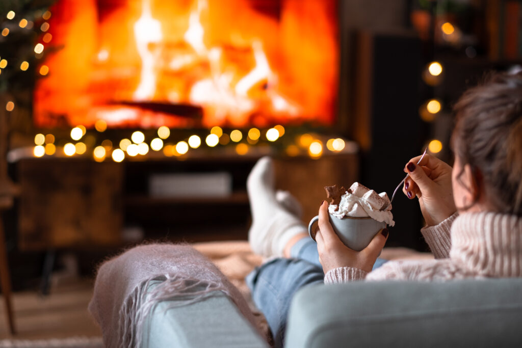 female relaxing on a sofa holding a mug on christmas 2 1024x683 - Acne Treatment Solutions For Adults