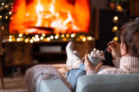 Female relaxing on a sofa holding a mug on Christmas 2 - free stock photo