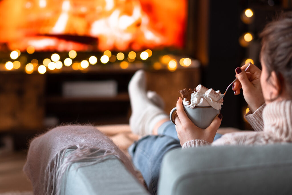 Female relaxing on a sofa holding a mug on Christmas 3 - free stock photo