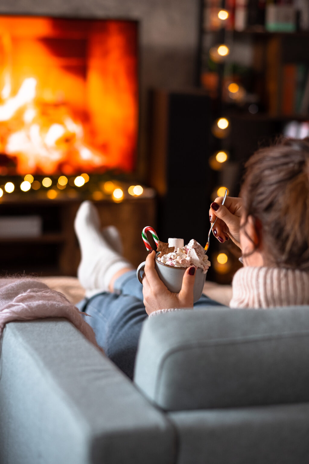 female relaxing on a sofa holding a mug on christmas 4 Tea Circle