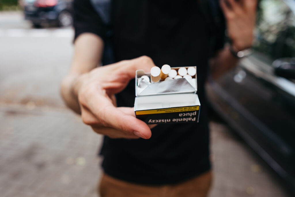 A male offering a cigarette - free stock photo