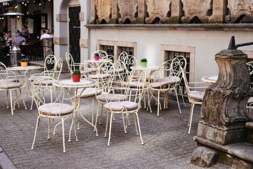 Vintage tables and chairs outside a cafe - free stock photo